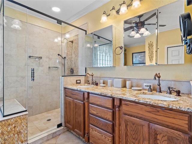 bathroom featuring ornamental molding, a sink, and a shower stall