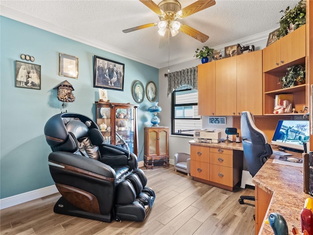 home office with crown molding, a textured ceiling, a ceiling fan, and light wood-style floors