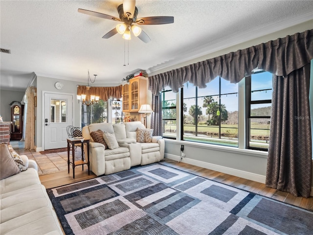 living room with ornamental molding, wood finished floors, and a wealth of natural light