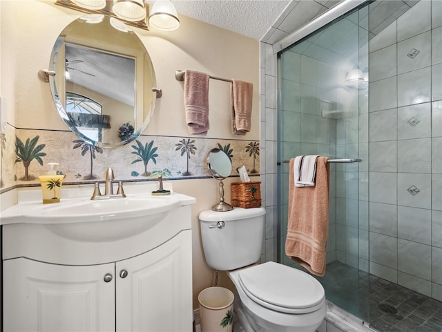 bathroom featuring toilet, a stall shower, a textured ceiling, and vanity