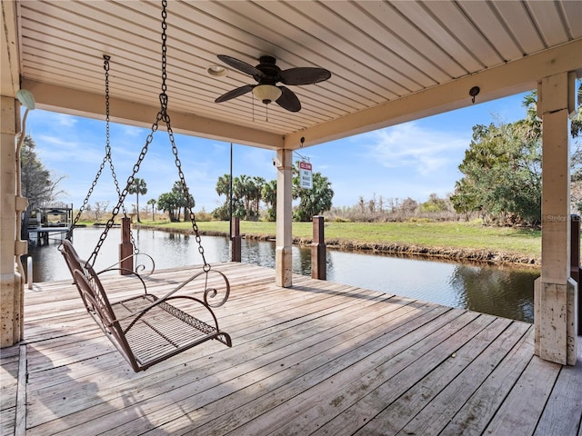 dock area with a water view and a lawn