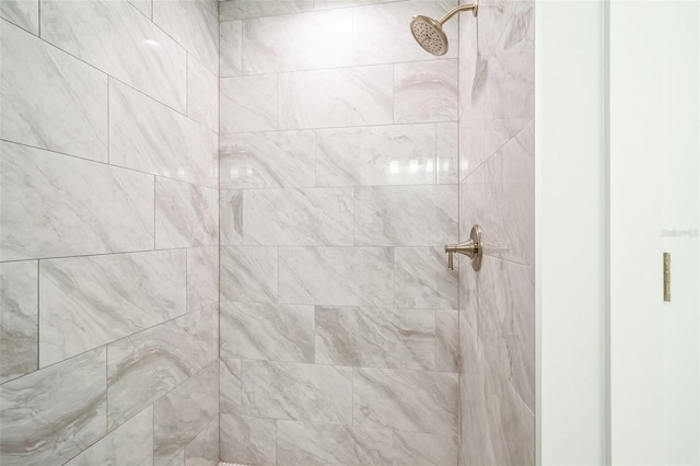 interior details with a tile shower