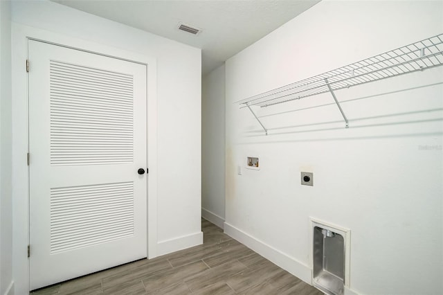 laundry room with visible vents, washer hookup, laundry area, light wood-style floors, and hookup for an electric dryer