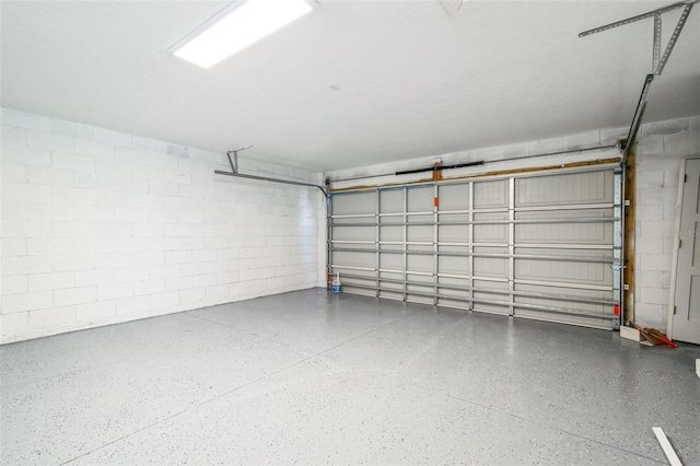 garage with concrete block wall