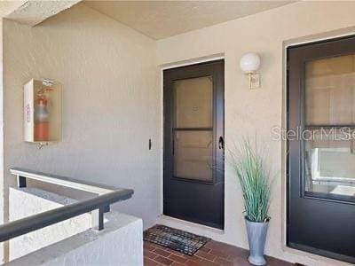 view of exterior entry featuring stucco siding