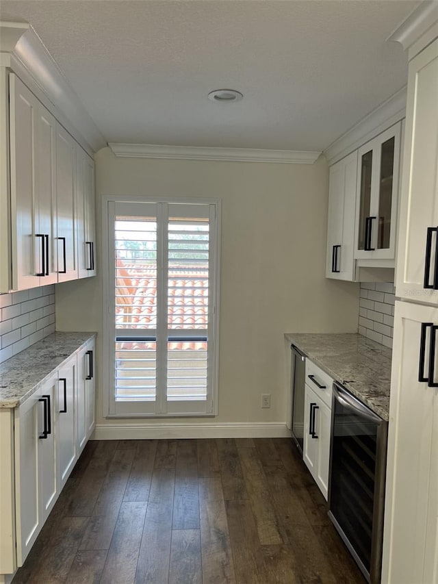 kitchen with crown molding, dark wood-type flooring, white cabinetry, light stone countertops, and beverage cooler