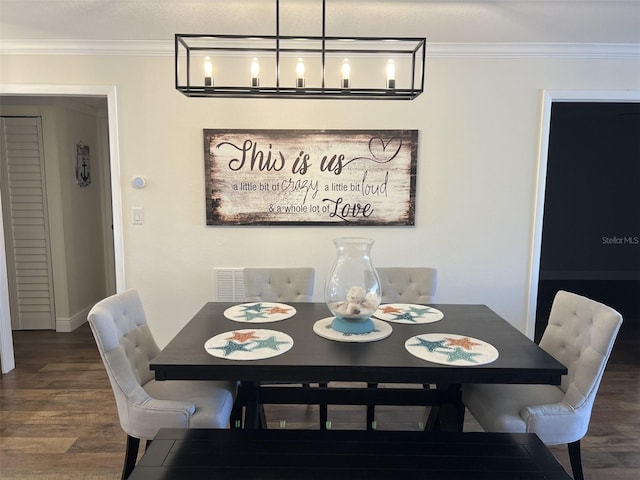 dining room featuring crown molding and wood finished floors