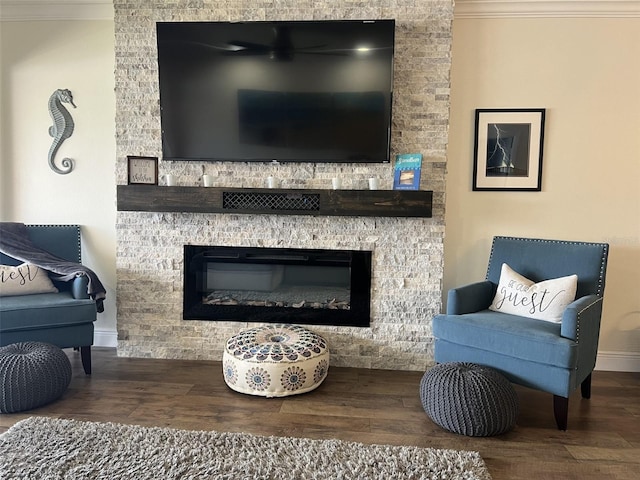 sitting room featuring crown molding, a fireplace, and wood finished floors