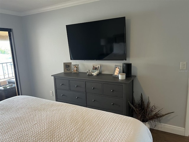 bedroom with baseboards, dark wood-style flooring, and crown molding