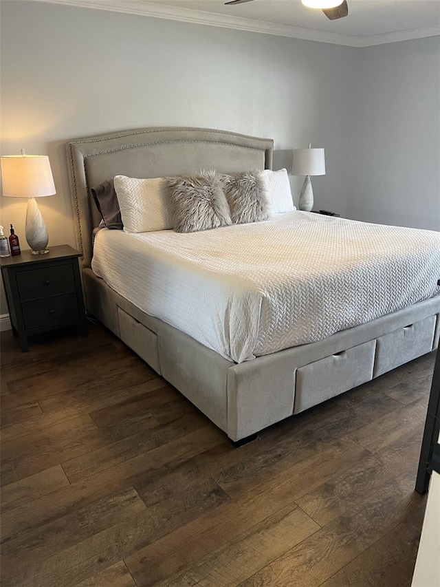 bedroom with crown molding and dark wood-style flooring