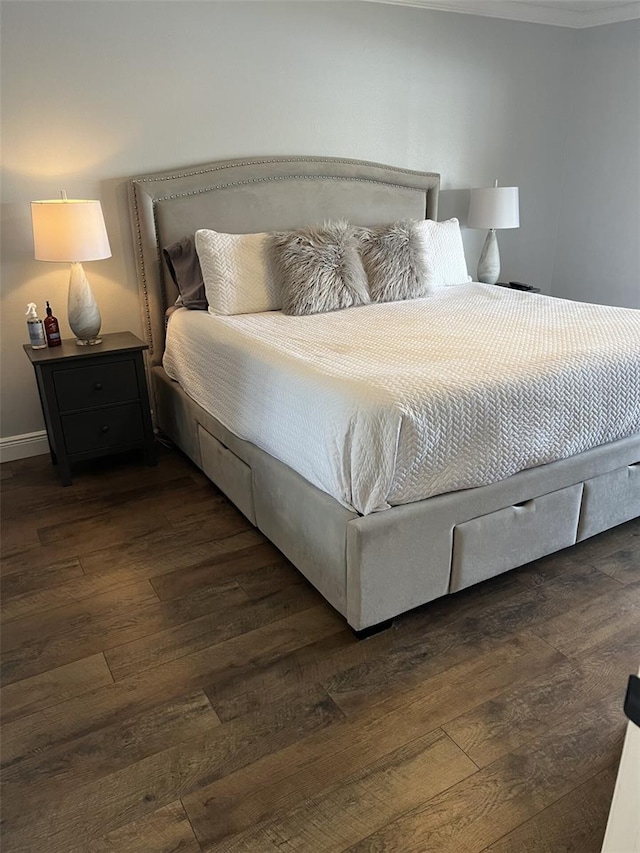 bedroom featuring dark wood-style flooring and baseboards