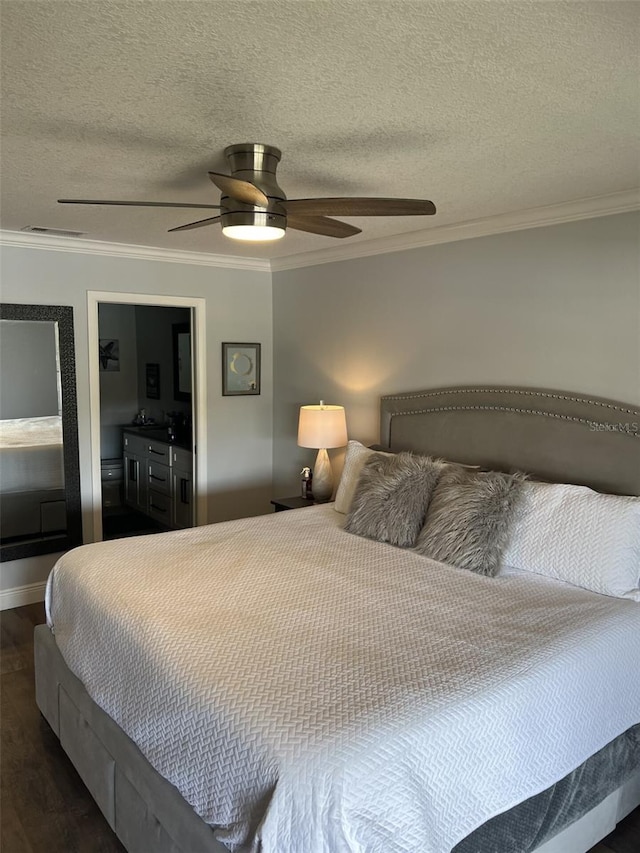 bedroom featuring dark wood-style floors, visible vents, ornamental molding, and a textured ceiling