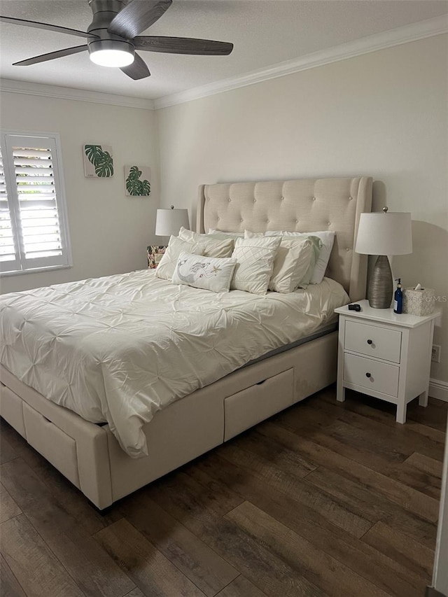 bedroom with ornamental molding, ceiling fan, and dark wood-type flooring