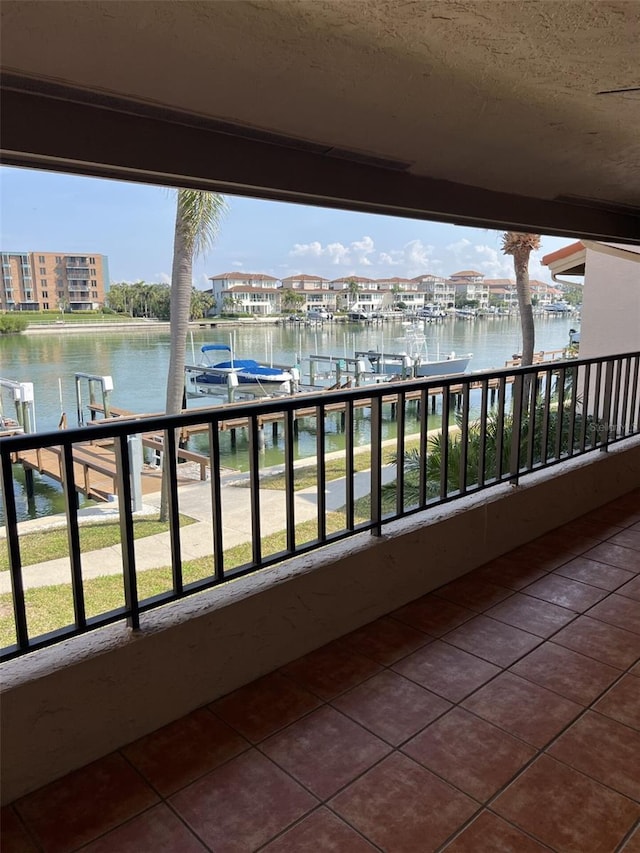 balcony with a boat dock and a water view