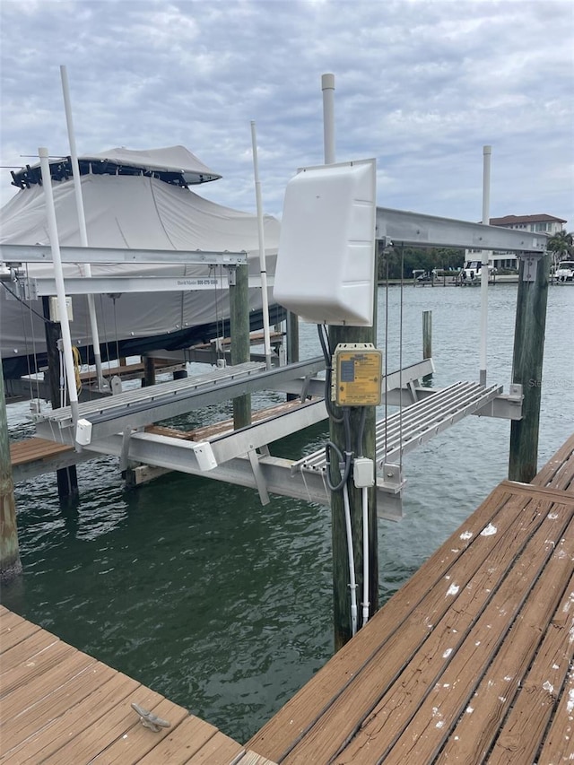 view of dock featuring a water view and boat lift