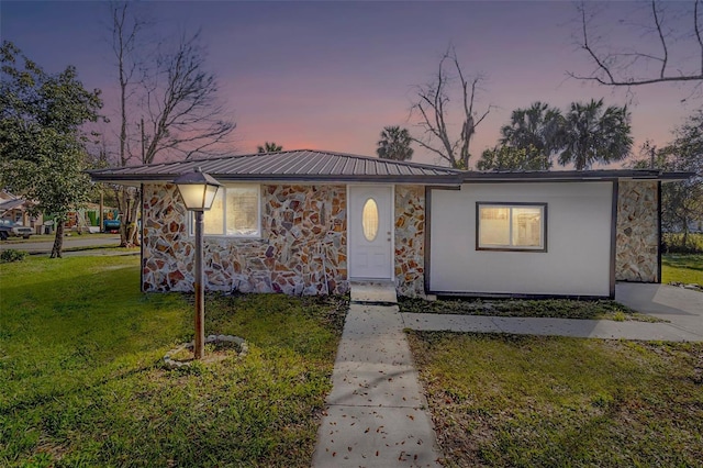 1203 S Pomegranite Ave, Sanford, FL 32771 - view of front of home with stone siding, metal roof, and a front yard