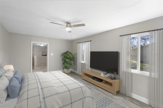1203 S Pomegranite Ave, Sanford, FL 32771 - bedroom with ceiling fan, light wood-type flooring, baseboards, and ensuite bathroom