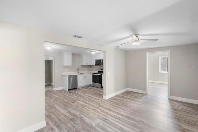 1203 S Pomegranite Ave, Sanford, FL 32771 - kitchen with a sink, stainless steel appliances, light countertops, white cabinets, and baseboards