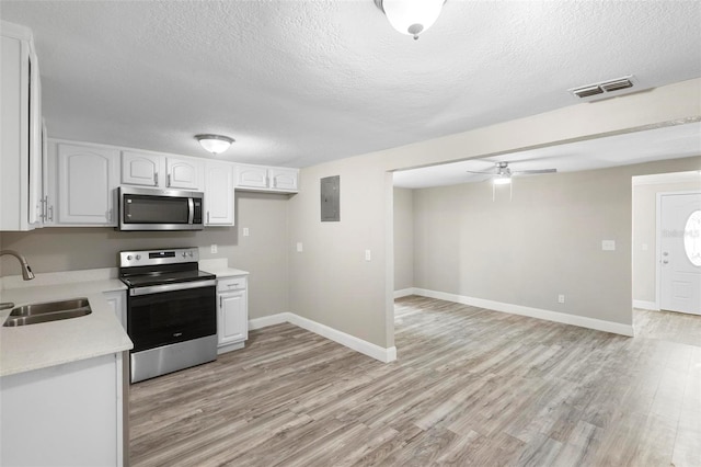 1203 S Pomegranite Ave, Sanford, FL 32771 - kitchen with light countertops, a sink, a textured ceiling, and appliances with stainless steel finishes