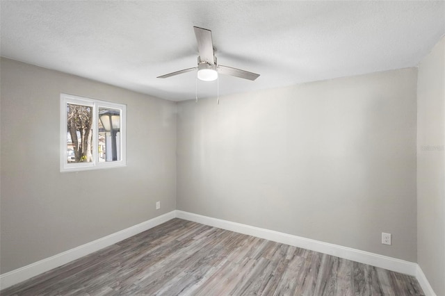 1203 S Pomegranite Ave, Sanford, FL 32771 - empty room with wood finished floors, a textured ceiling, a ceiling fan, and baseboards