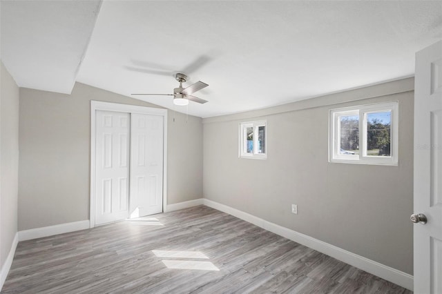 1203 S Pomegranite Ave, Sanford, FL 32771 - unfurnished bedroom with baseboards, lofted ceiling, wood finished floors, a closet, and ceiling fan