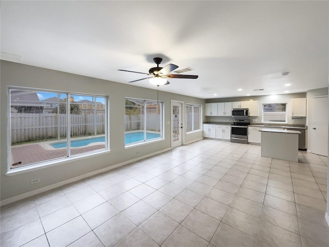 kitchen with light tile patterned floors, visible vents, appliances with stainless steel finishes, and white cabinets