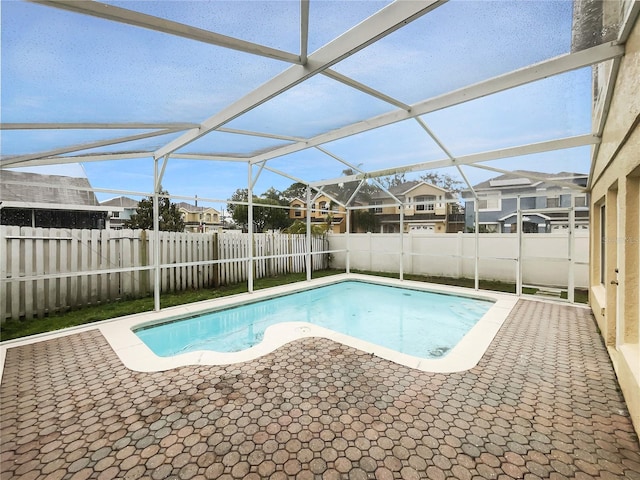 view of pool with a fenced in pool, a fenced backyard, a residential view, a lanai, and a patio area