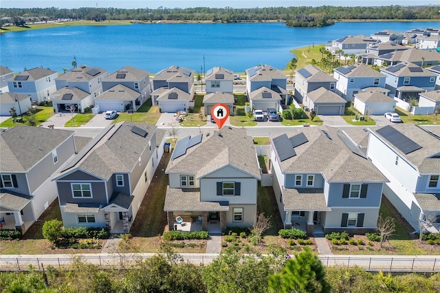 drone / aerial view featuring a water view and a residential view