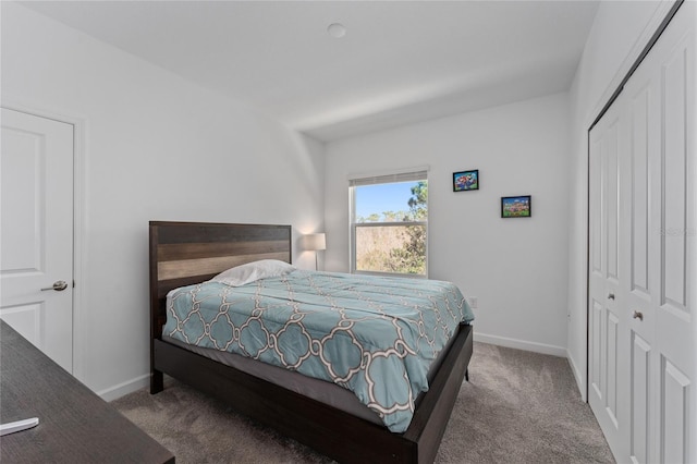 bedroom with carpet, a closet, and baseboards