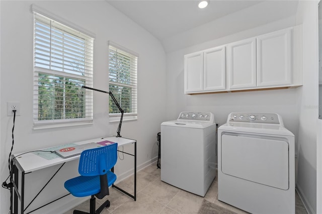 laundry room featuring light tile patterned flooring, independent washer and dryer, cabinet space, and baseboards