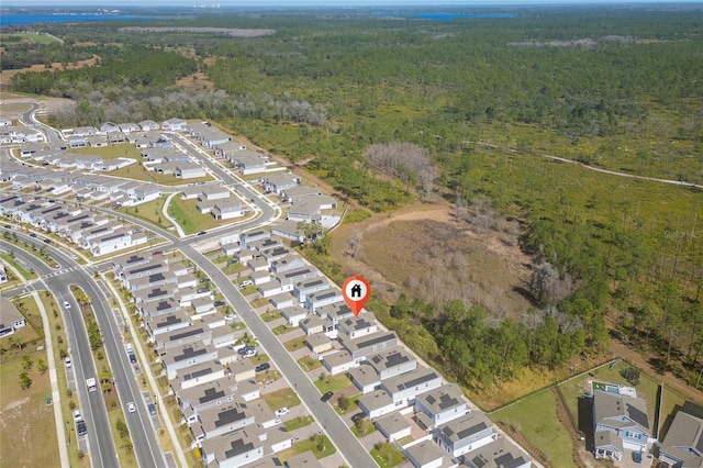 birds eye view of property with a forest view and a residential view