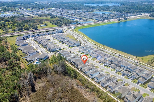 birds eye view of property with a water view and a residential view