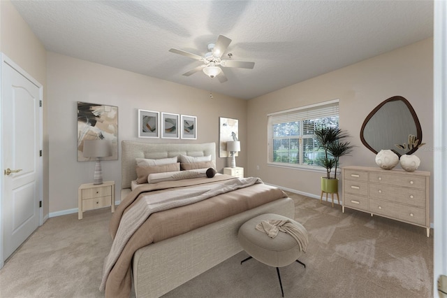 bedroom with carpet flooring, ceiling fan, a textured ceiling, and baseboards