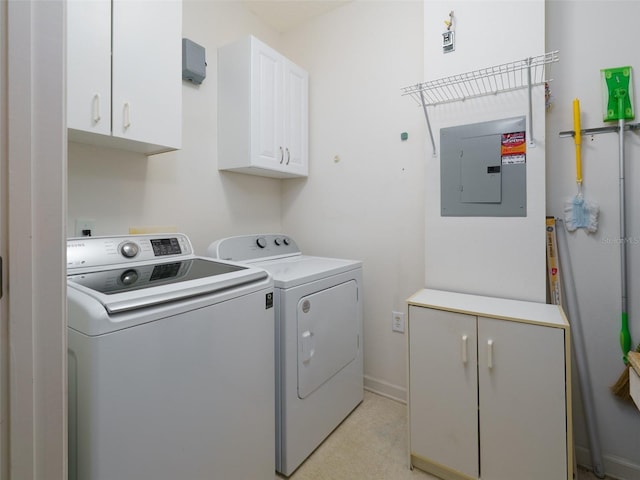 clothes washing area featuring separate washer and dryer, cabinet space, electric panel, and baseboards