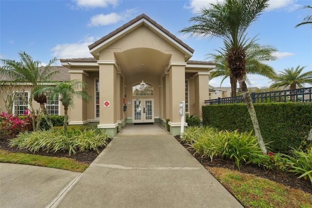 entrance to property with french doors and stucco siding