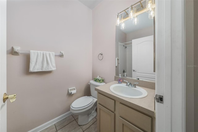 bathroom with toilet, vanity, tile patterned flooring, baseboards, and walk in shower