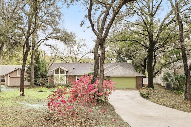 view of front of house with a garage, brick siding, driveway, roof with shingles, and a chimney