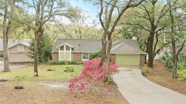 view of front of home with a front yard, brick siding, driveway, and an attached garage