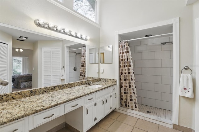 bathroom featuring tile patterned floors, ensuite bath, tiled shower, and vanity