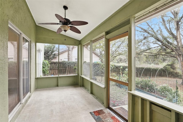 unfurnished sunroom with vaulted ceiling and ceiling fan