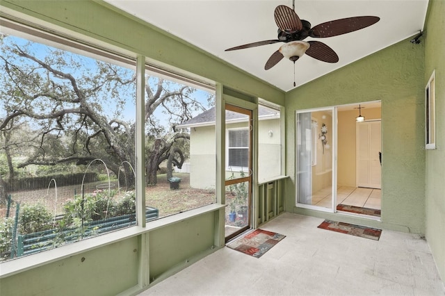 unfurnished sunroom with vaulted ceiling and ceiling fan