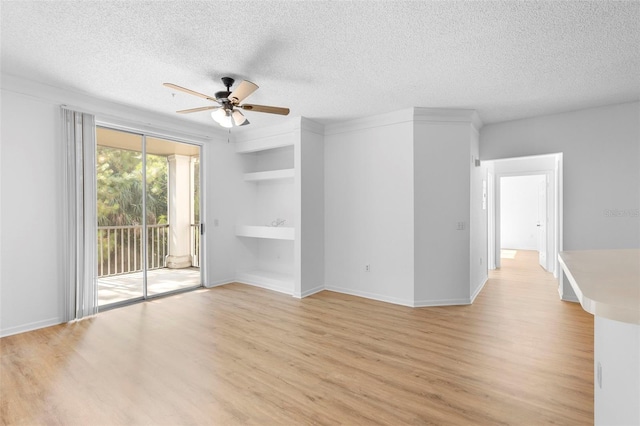 13037 Mulberry Park Dr Unit 529, Orlando, FL 32821 - unfurnished room with ceiling fan, light wood-style floors, and a textured ceiling