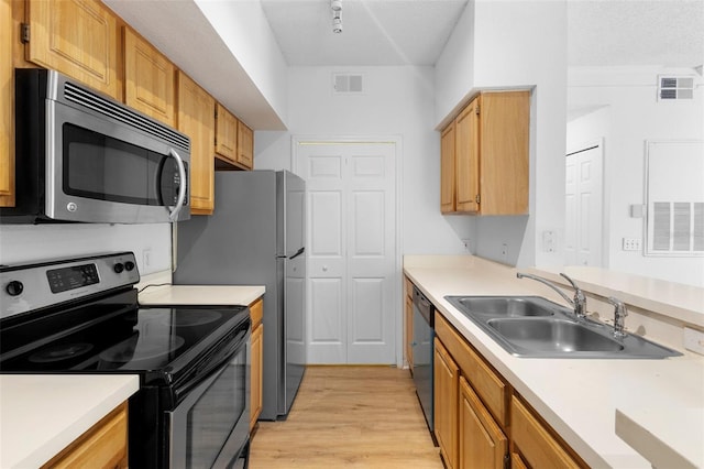13037 Mulberry Park Dr Unit 529, Orlando, FL 32821 - kitchen with stainless steel appliances, light wood-style floors, light countertops, and a textured ceiling
