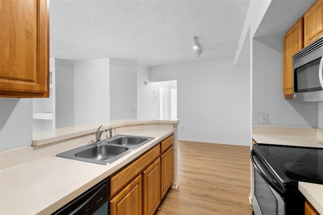 13037 Mulberry Park Dr Unit 529, Orlando, FL 32821 - kitchen with light wood-style flooring, stainless steel appliances, light countertops, brown cabinetry, and a textured ceiling