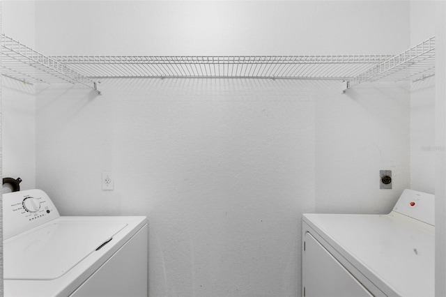 13037 Mulberry Park Dr Unit 529, Orlando, FL 32821 - washroom featuring independent washer and dryer and a textured wall