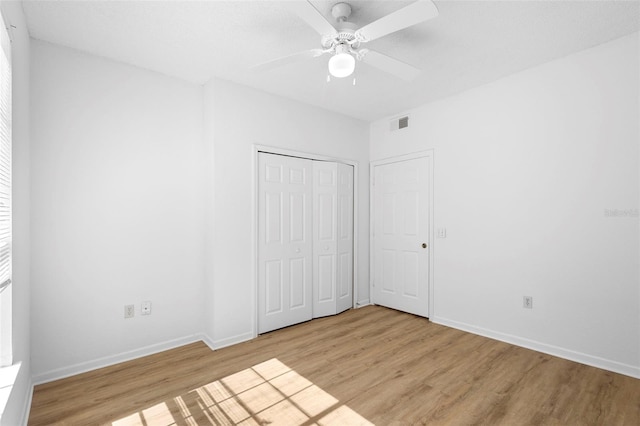13037 Mulberry Park Dr Unit 529, Orlando, FL 32821 - unfurnished bedroom featuring light wood-type flooring, a closet, and a ceiling fan