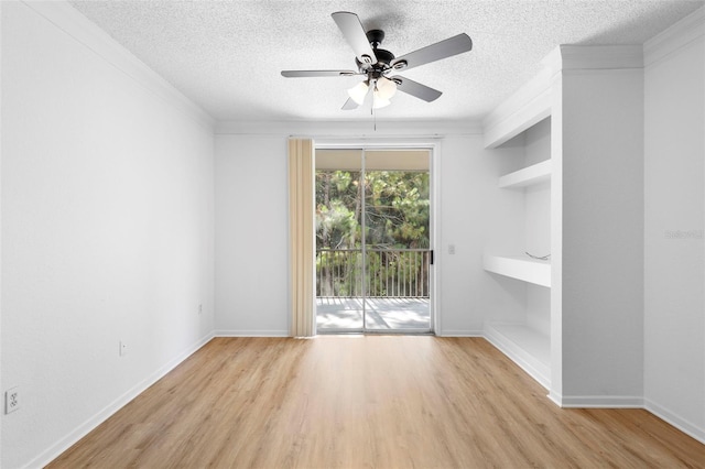13037 Mulberry Park Dr Unit 529, Orlando, FL 32821 - empty room featuring a textured ceiling, wood finished floors, a ceiling fan, built in features, and crown molding