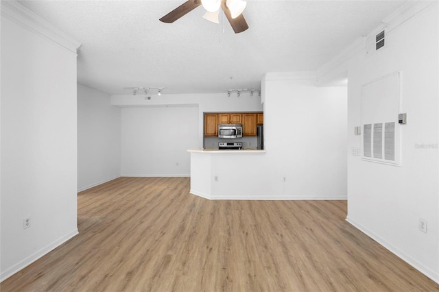 13037 Mulberry Park Dr Unit 529, Orlando, FL 32821 - unfurnished living room featuring ceiling fan, light wood-style floors, a textured ceiling, rail lighting, and ornamental molding