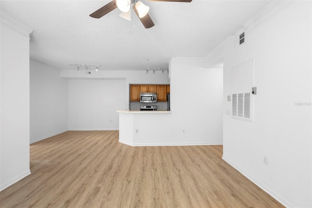 13037 Mulberry Park Dr Unit 529, Orlando, FL 32821 - unfurnished living room featuring a ceiling fan, light wood finished floors, track lighting, and a textured ceiling