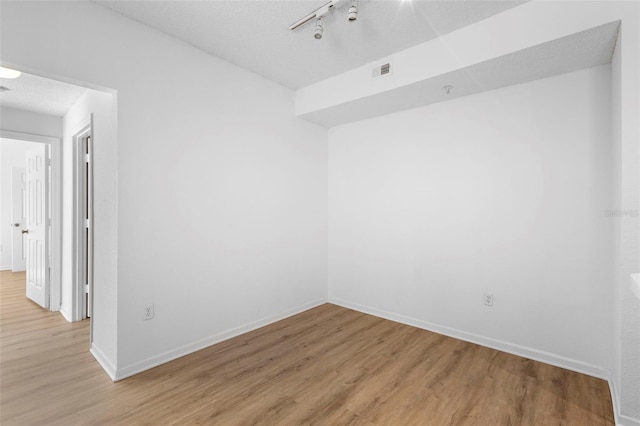 13037 Mulberry Park Dr Unit 529, Orlando, FL 32821 - spare room featuring light wood finished floors and a textured ceiling